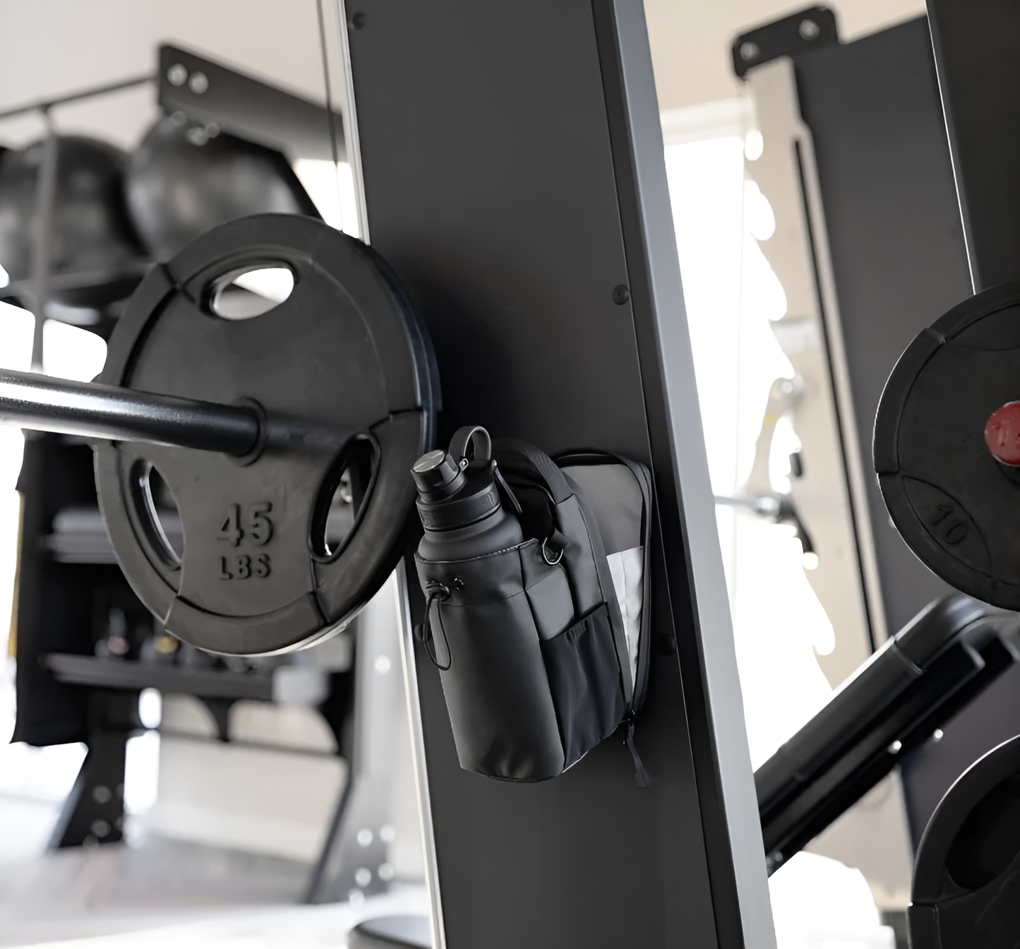 Black weight plate attached to a barbell with a gym background