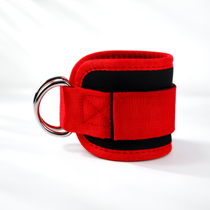 Red and black wrist restraint with a metal ring on a white background
