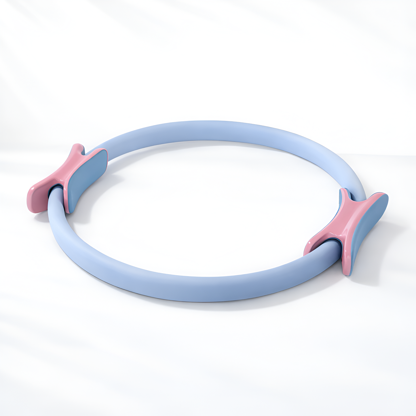 Light blue Pilates ring with pink handles on a white background