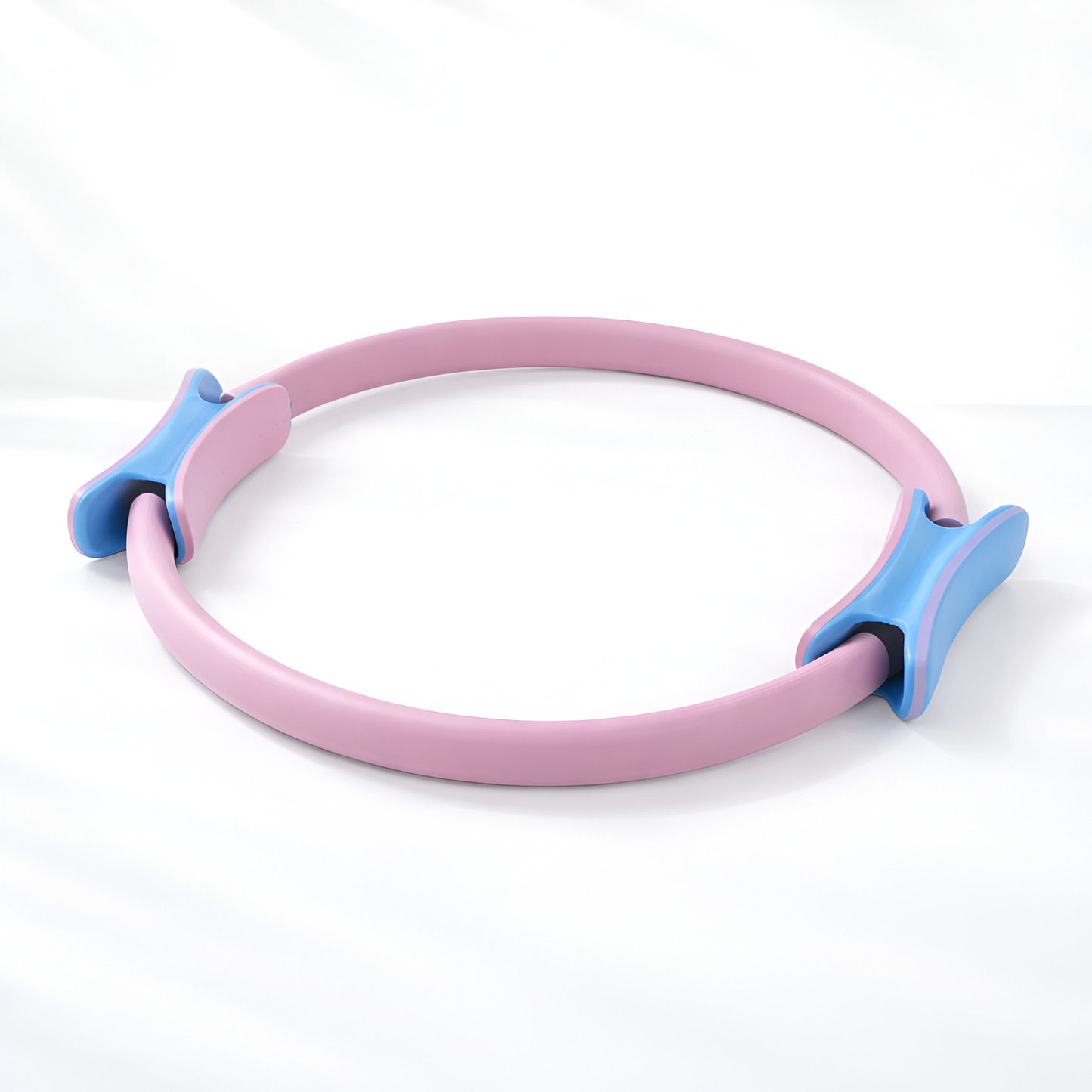 Pink and blue Pilates ring on a white background