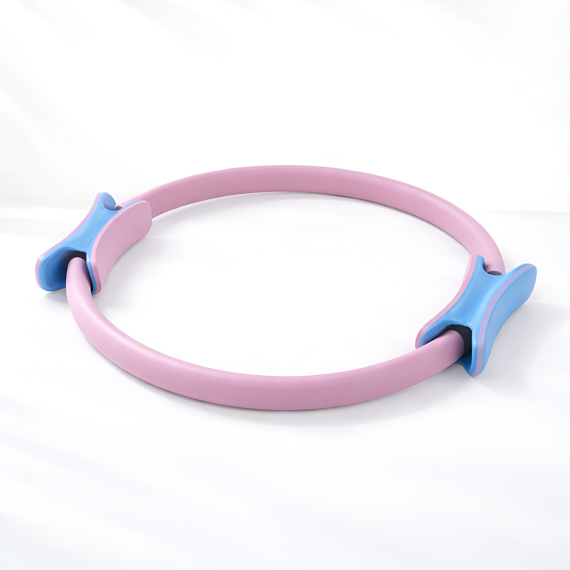 Pink and blue Pilates ring on a white background