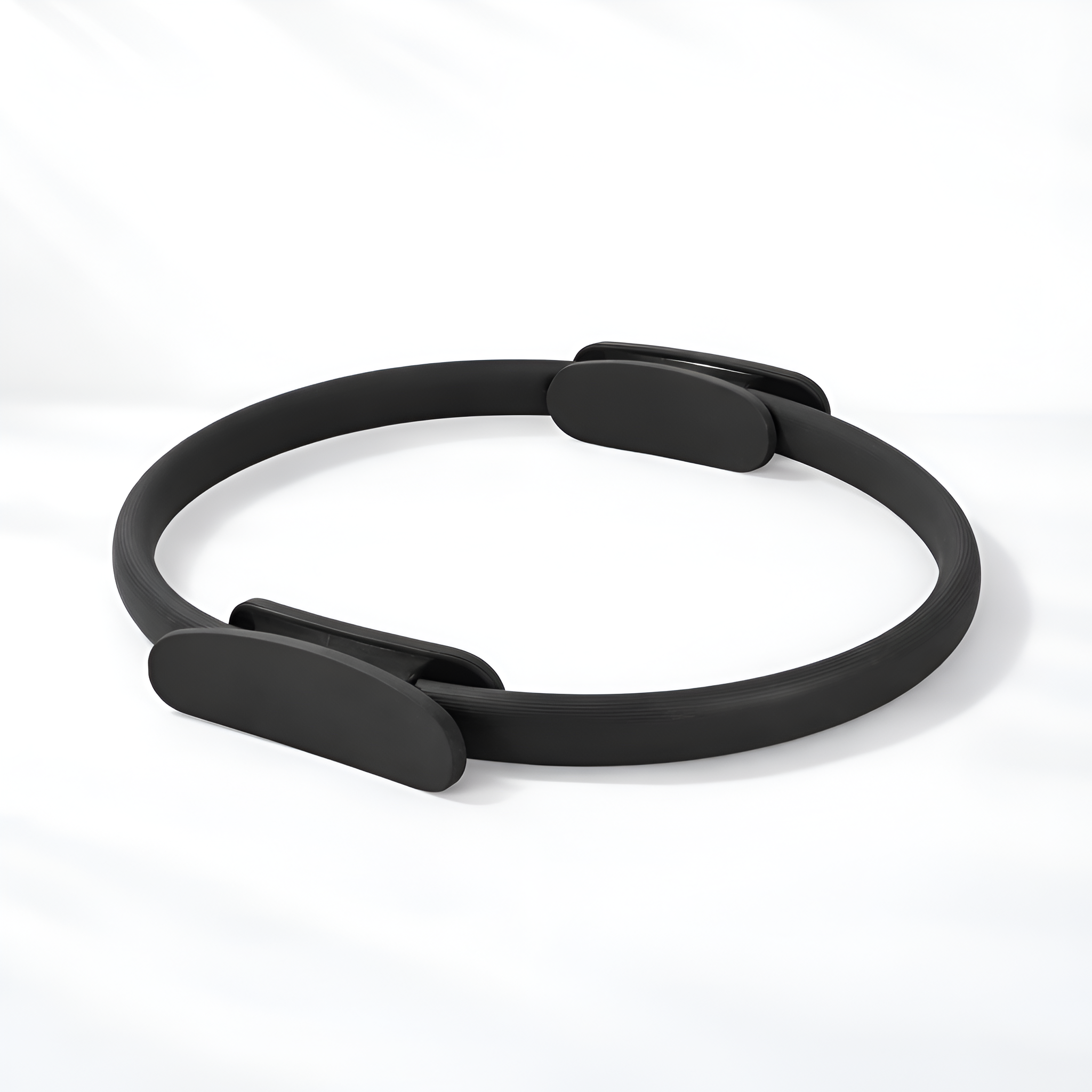 Black Pilates ring on a white background