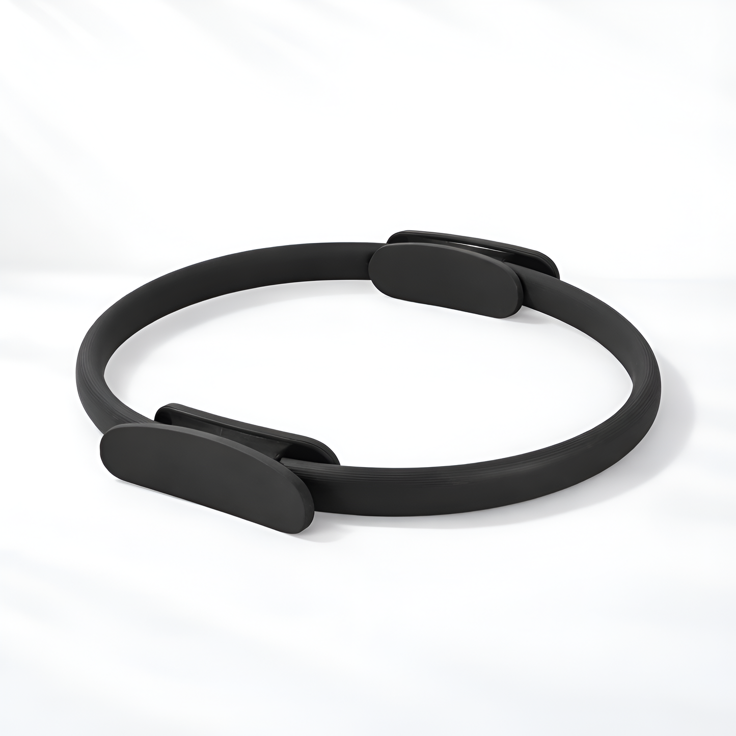 Black Pilates ring on a white background