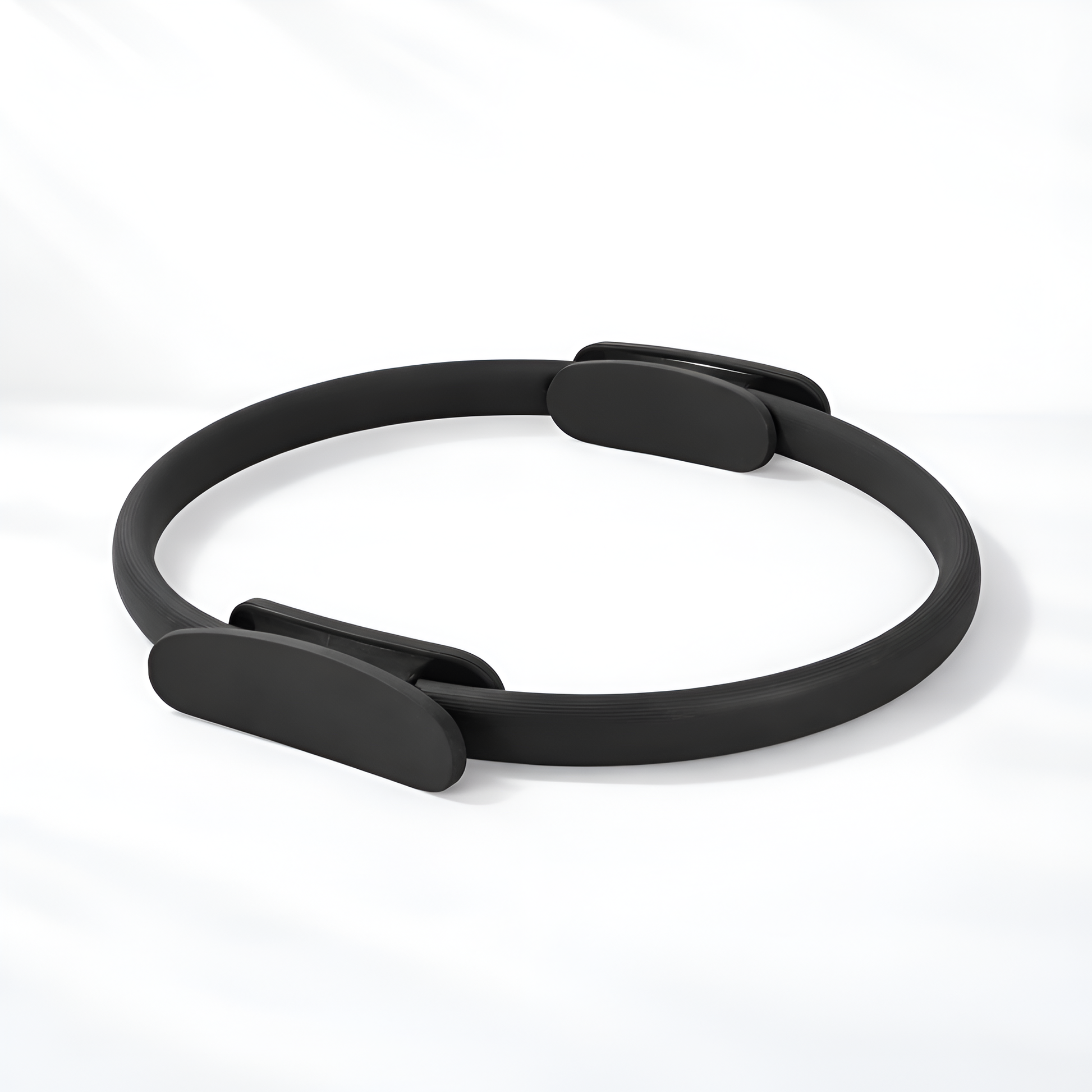 Black Pilates ring on a white background