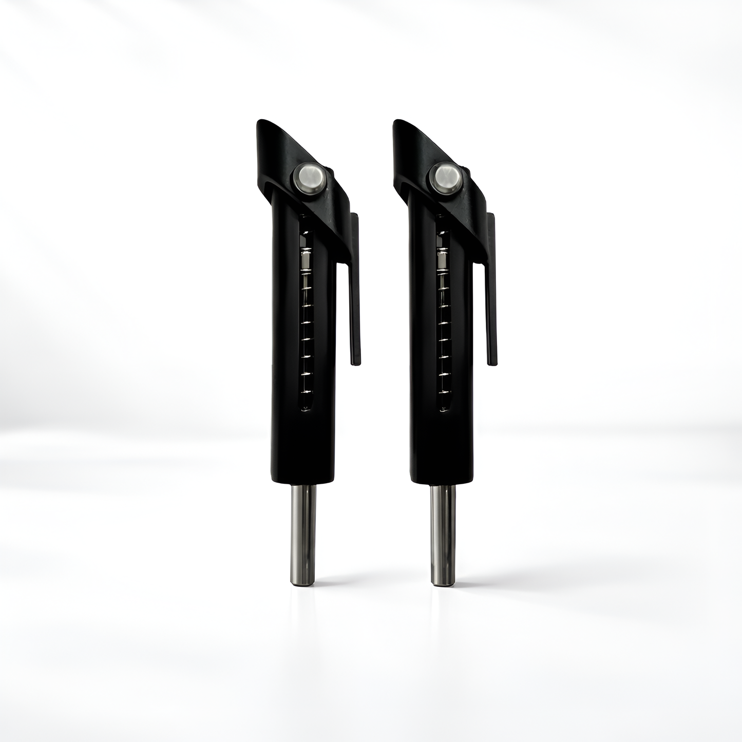 Two black metal tools with silver accents on a white background