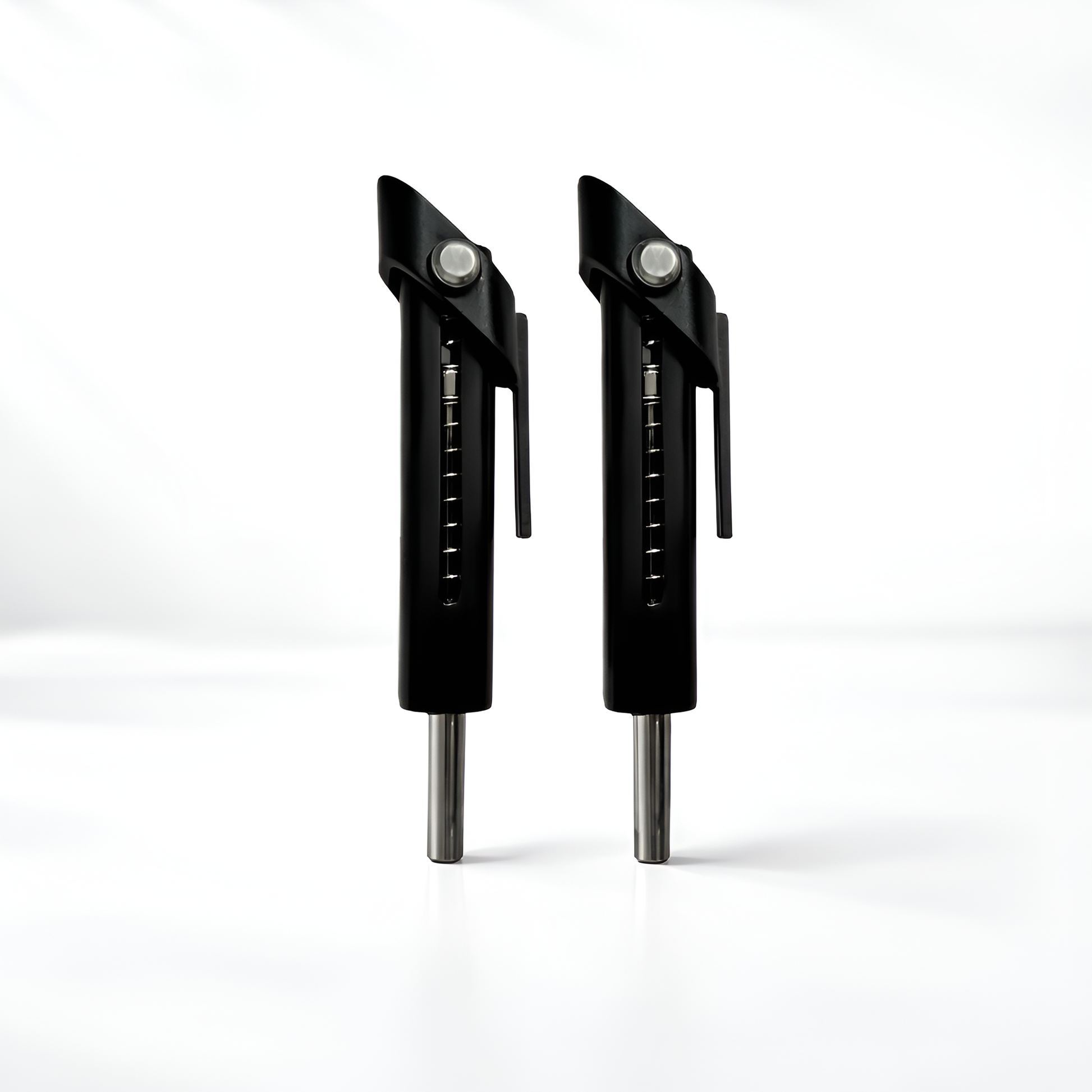 Two black metal tools with silver accents on a white background