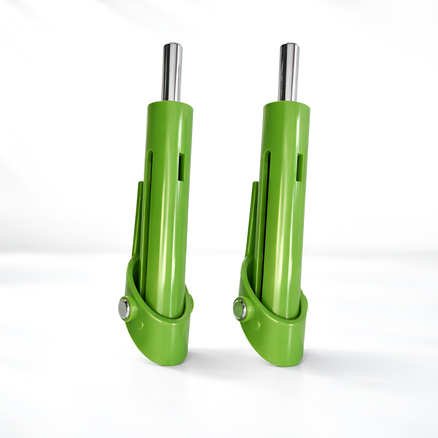 Two green metal tools with silver ends on a white background
