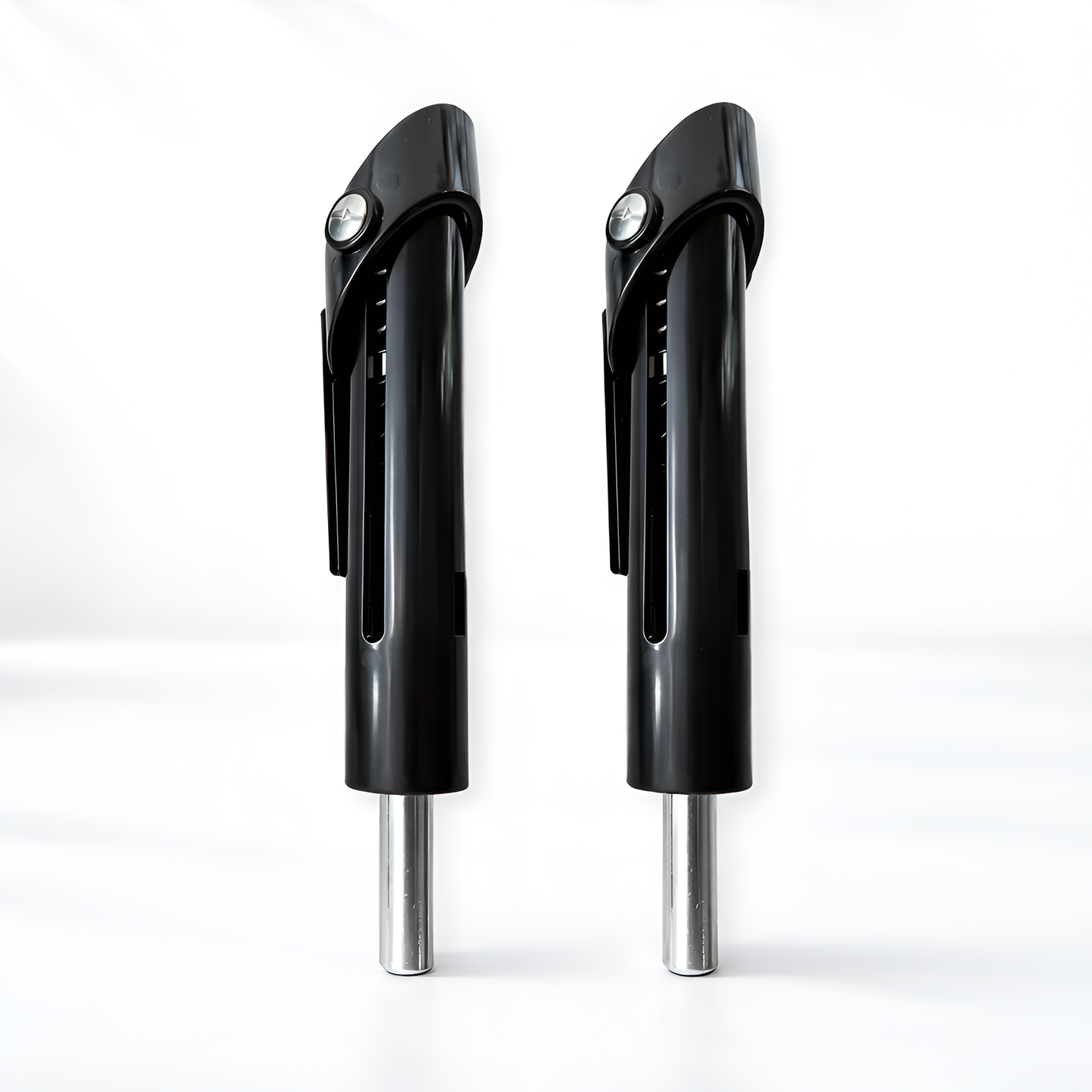 Two black and silver can openers on a white background