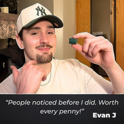 Dropset™ Official JawFlex jaw exerciser in green, held by a young man wearing a white t-shirt and a baseball cap.