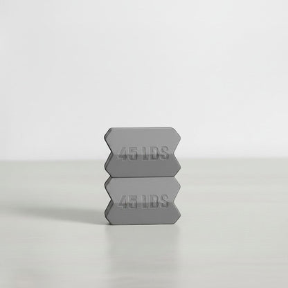 Dropset™ Official grey 45 lb weight plates stacked, designed for strength training.