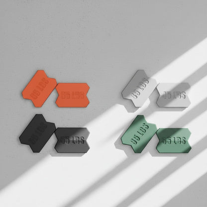 Dropset™ Official JawFlex weight plates in orange, grey, black, and green, each marked with weight.